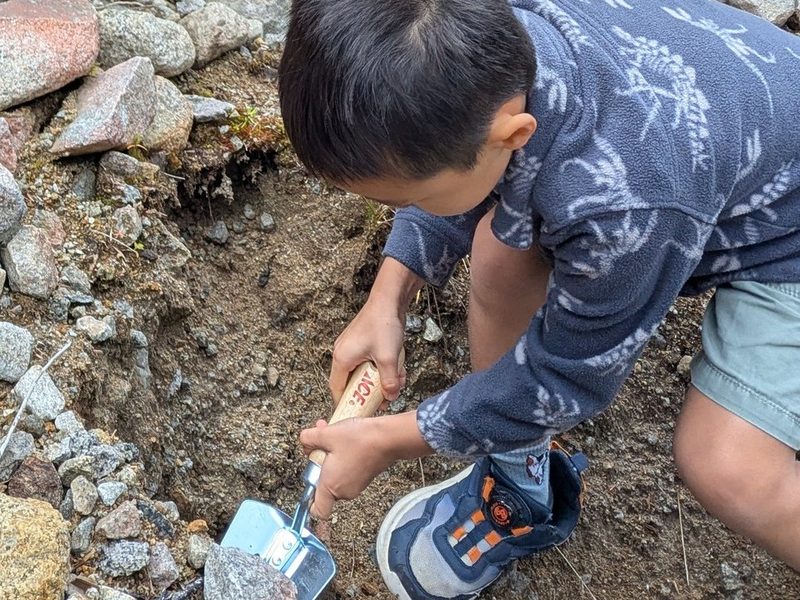 Linh Tinh digging for rocks
